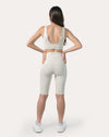 Full-body back view wearing ivory high-waist longline bike shorts