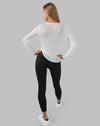 Back full-length view of white ladies long sleeve gym top showing relaxed longline fit