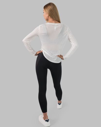 Back full-length view of white ladies long sleeve gym top showing relaxed longline fit