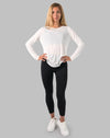 Front full-length, hands on hips; white ladies long sleeve gym top with breathable sheer knit