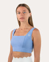 Right front three-quarter view of light blue square neck sports bra with wide straps