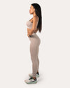 Side profile of light grey gym set highlighting sculpting high-waist leggings and wide waistband