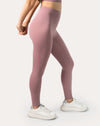 Front close-up of the light pink gym leggings and top set, longline V-neck bra with arms stretched