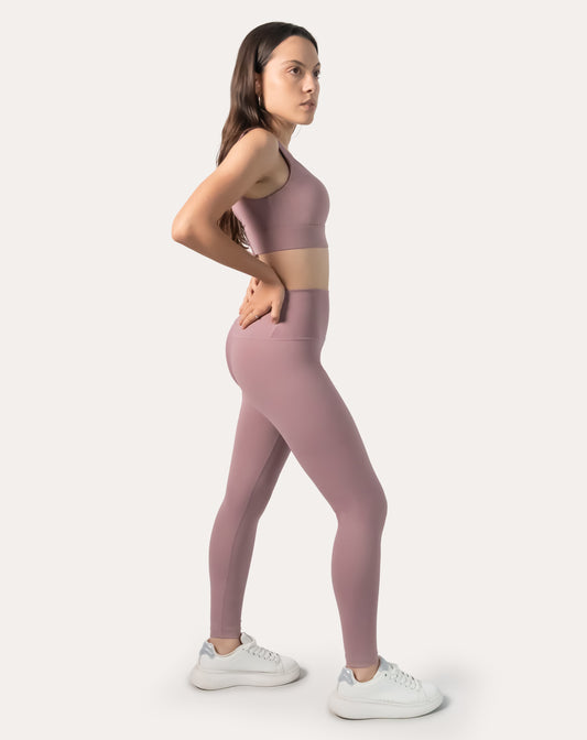 3/4 side profile of light pink gym leggings and top set showing smooth high-waist leggings