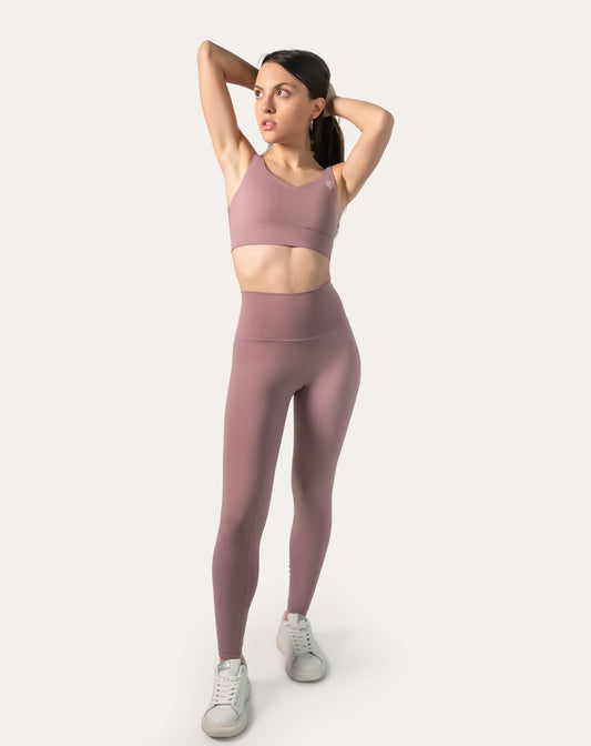 Front view of light pink gym leggings and top set with V-neck longline clasp-back bra and high-waist leggings