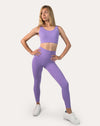Lilac gym set front view on model: racerback bra and high-waist leggings for women