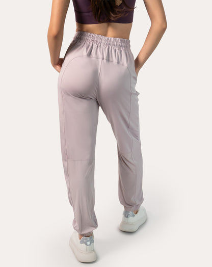 Lilac joggers for women, back view showing high-rise waistband, tapered legs and elastic cuffs