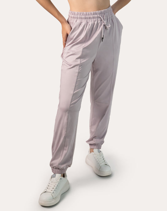 Lilac joggers for women, left three-quarter front with hands in pockets and tapered legs