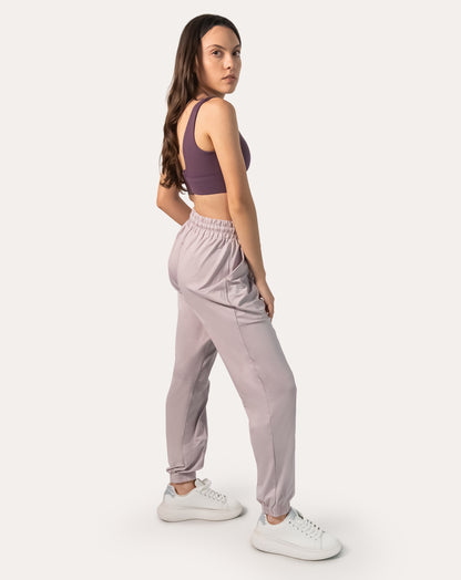 Lilac joggers for women, left three-quarter full-length stance with elastic cuffs