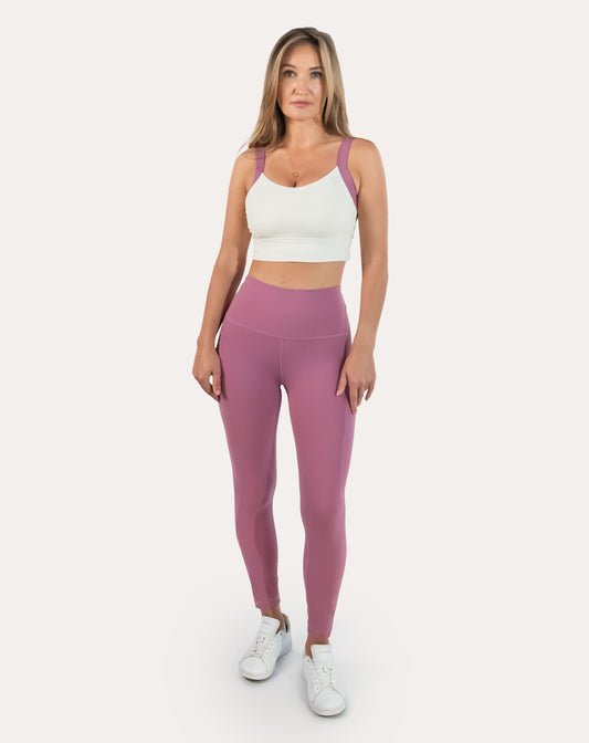 Front view of lilac pocket leggings gym set with contrast-strap longline bra and high-waist leggings.