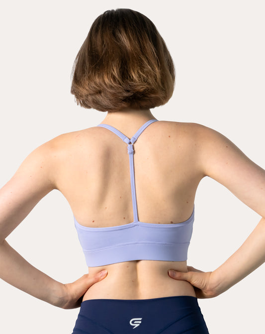 Back view of lilac racerback sports bra showing adjustable T-back and supportive underband