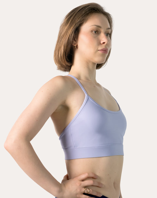 Front three-quarter of lilac racerback sports bra with scoop neck and thin straps