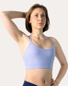 Side profile of lilac racerback sports bra highlighting scoop neck and smooth underband