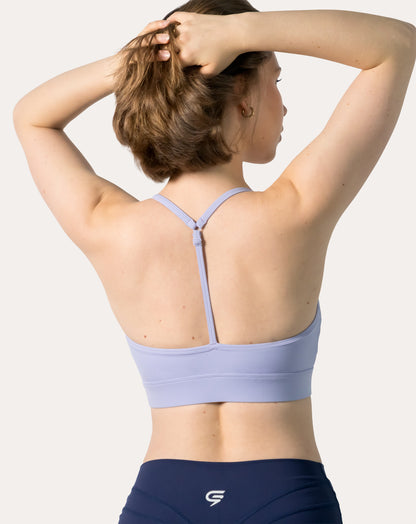 Close-up of lilac racerback sports bra’s T-back strap detail