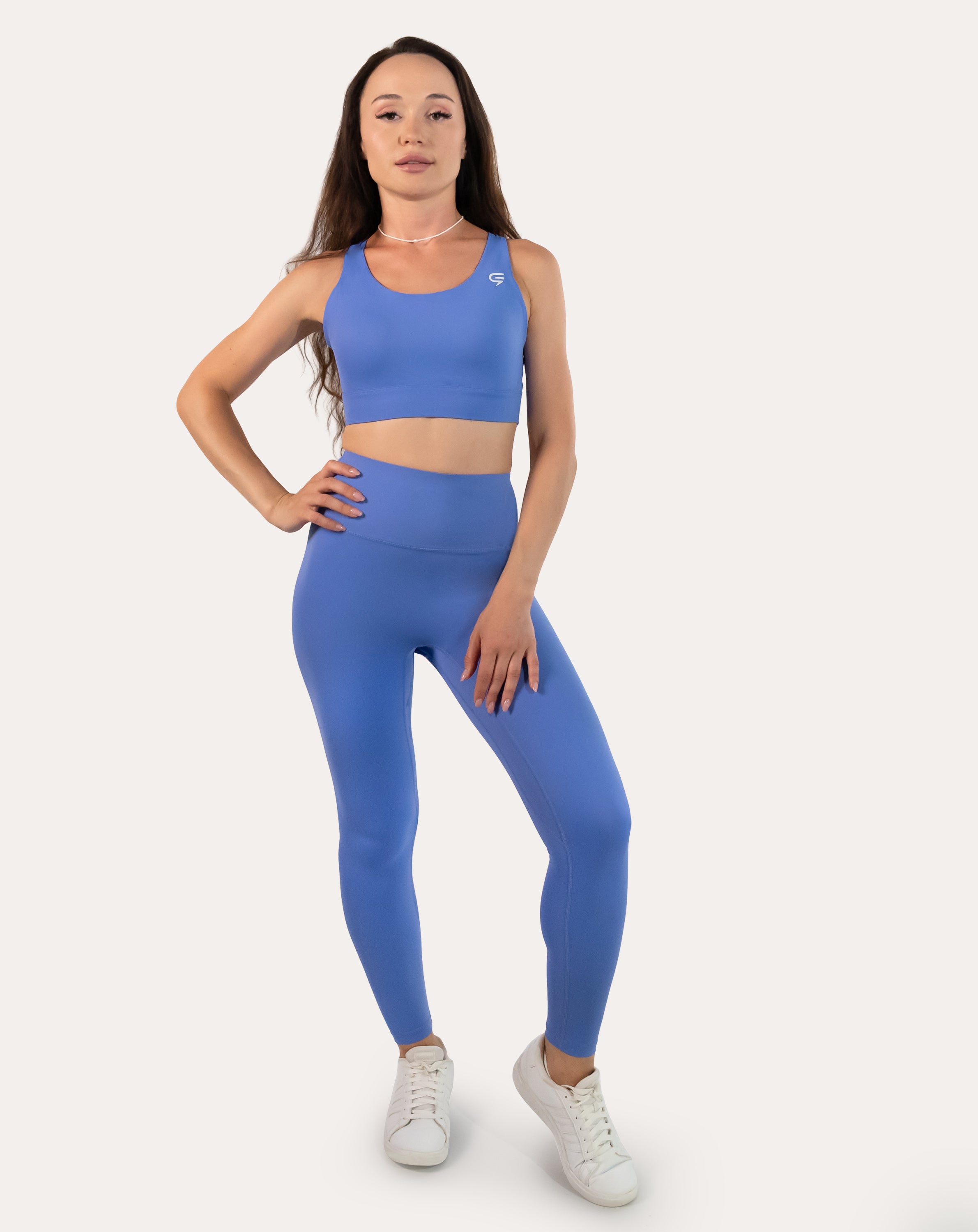 Sapphire blue matching gym set, full front view of racerback bra and high-waist leggings