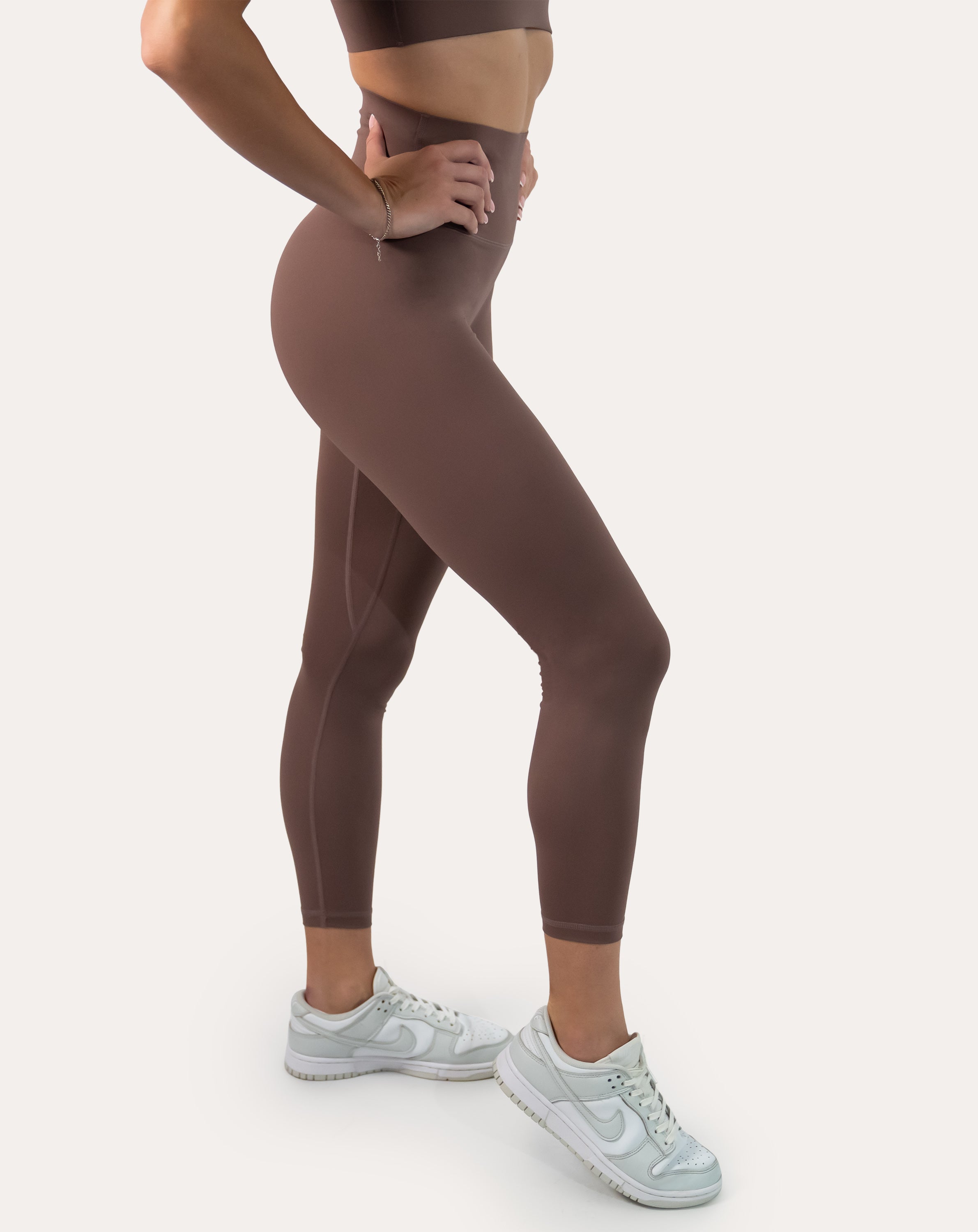 Side close-up of mocha gym set leggings with high waistband and streamlined seams