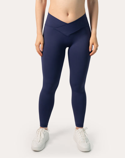 Navy scrunch bum leggings; front crossover V-waist close-up from waist to ankle