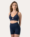Navy sports bra full-length front view highlighting V-neck, small keyhole and wide underband