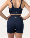 Back close-up of navy sports shorts highlighting high waist, no slip waistband, and V glute seams