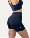 Back left three-quarter close-up of navy sports shorts showing high waist, logo, and glute-contour seams