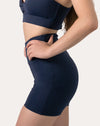 Right side close-up of navy sports shorts showing sculpted fit and flatlock seams
