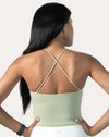 Sage green open back gym top, back view displaying crossed straps and open back