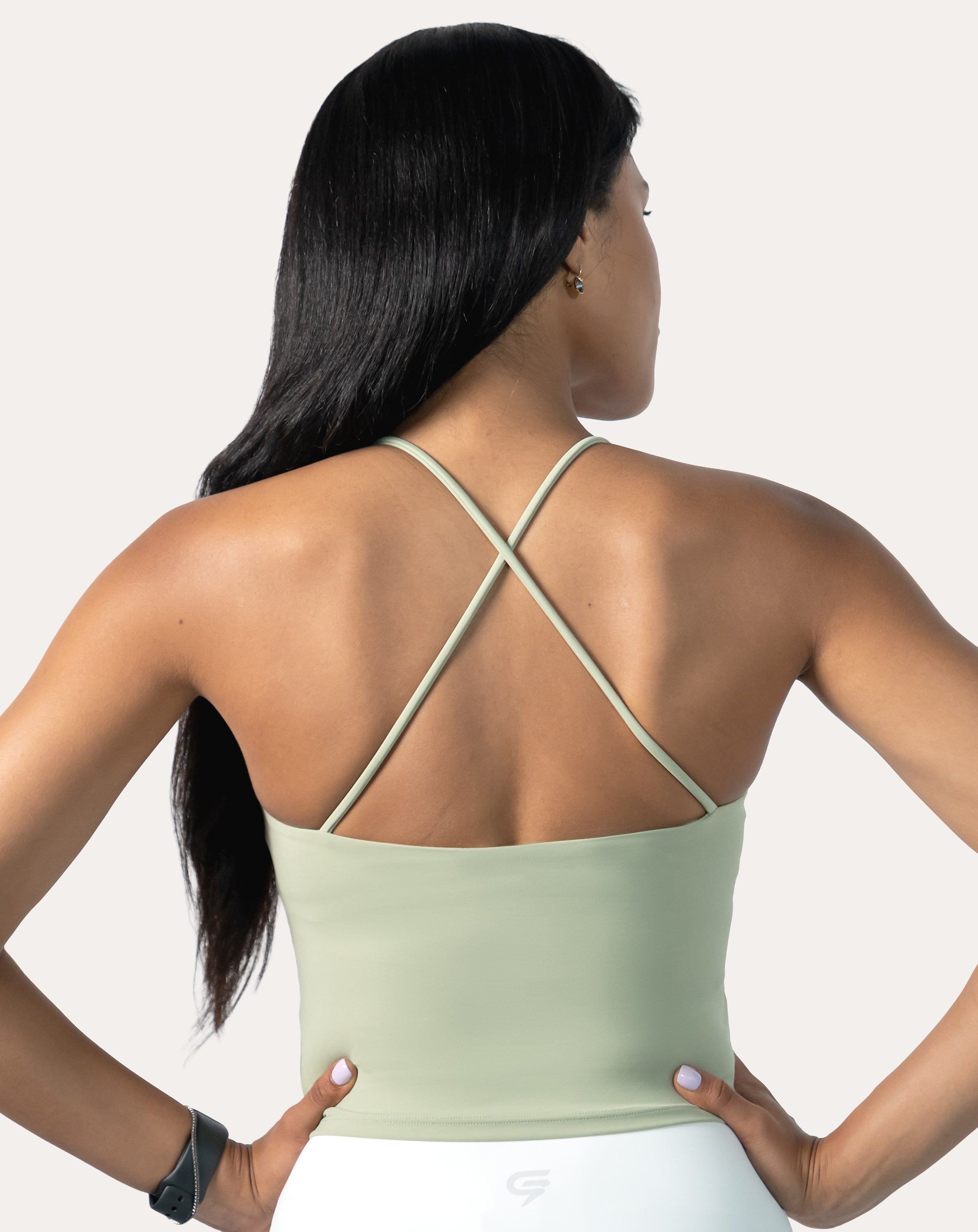 Sage green open back gym top, back view displaying crossed straps and open back