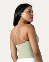 Sage green open back gym top, three-quarter back view highlighting strappy cross-back.