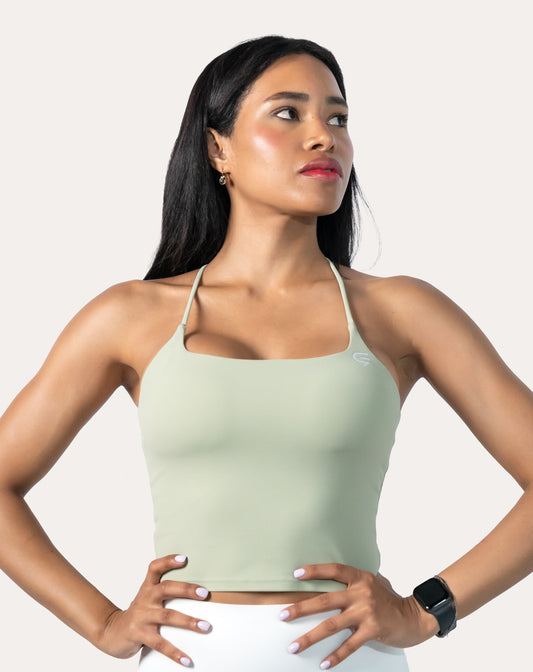 Sage green open back gym top, front three-quarter view with square neckline and thin straps