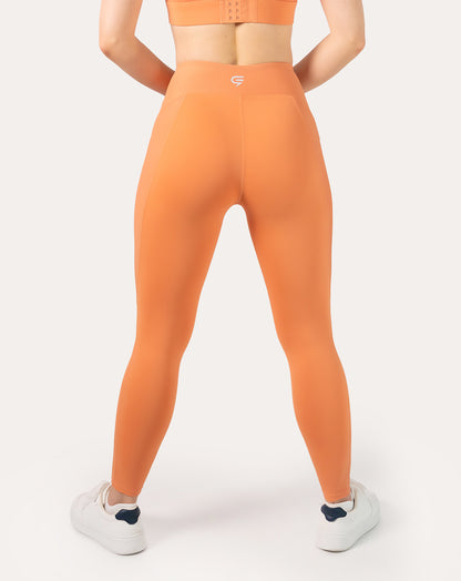 Orange gym leggings with high waisted fit; straight back view