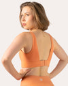 Front close-up of orange gym set bra showing square neckline and supportive straps