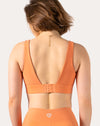 Back view of orange sports bra with deep V and adjustable hook-and-eye back closure
