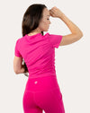 Back view of hot pink women’s gym top with smooth ribbed knit and breathable crew neck