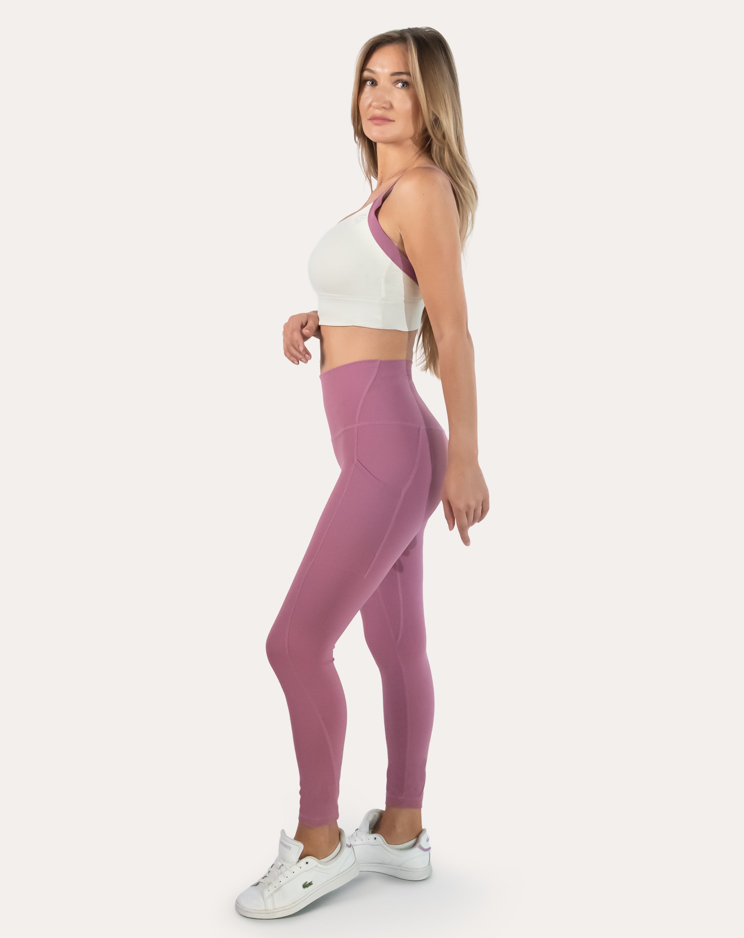 Pink leggings with pockets; front three quarter view with supportive high-waist