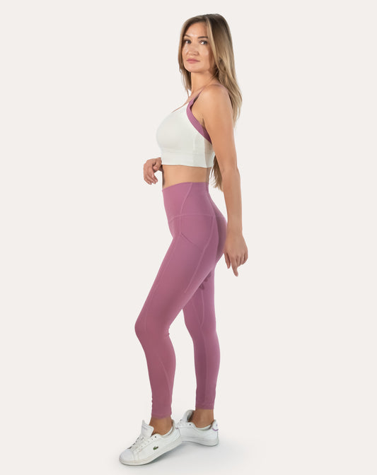 Pink leggings with pockets; front three quarter view with supportive high-waist