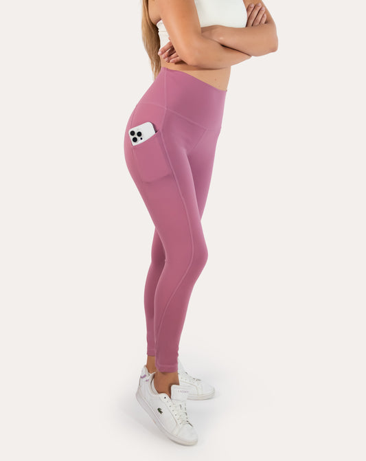 Pink leggings with pockets; high-waist left three quarter view showing phone pocket