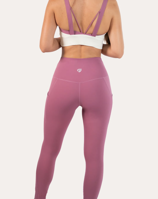 Pink leggings with pockets; right three quarter view in an athletic stance