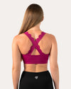 Back view of pink sports bra with crisscross straps and wide underband