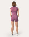 Back view highlighting breathable mesh back on crop top of plum gym shorts set