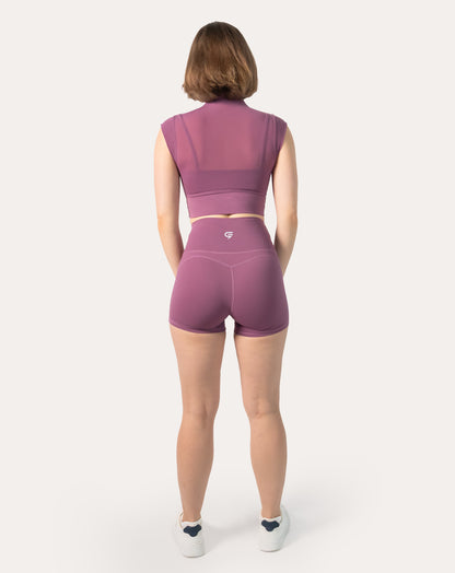 Back view highlighting breathable mesh back on crop top of plum gym shorts set