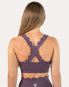 Straight back view of purple cross back sports bra with stabilizing crisscross straps