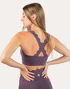 Back close-up of purple gym set highlighting X-back straps and scallop edges