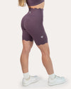Side detail of purple gym set biker shorts showing high-waist hold and hem length
