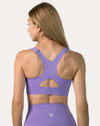 Mid-length back view of purple sports bra highlighting racerback cut and stabilising band