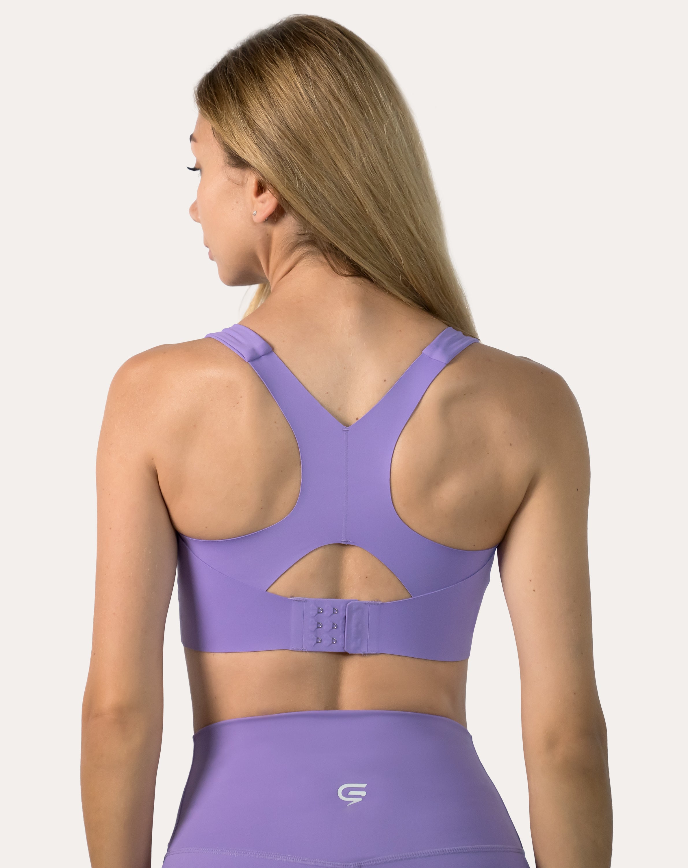 Mid-length back view of purple sports bra highlighting racerback cut and stabilising band