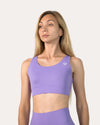 Straight front view of purple sports bra with smooth scoop neck and wide underband