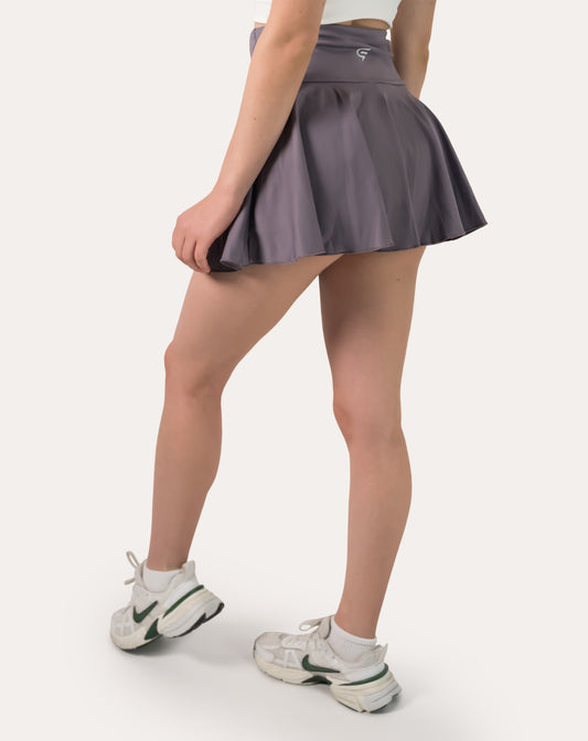 Right back three-quarter view of purple sports skirt with high waist and flowing flare