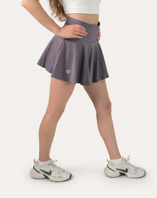 Front three-quarter close-up of purple sports skirt with high-rise waistband and flared hem