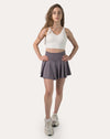 Full-body front view wearing a purple high-waist flared sports skirt