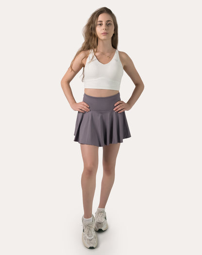 Full-body front view wearing a purple high-waist flared sports skirt